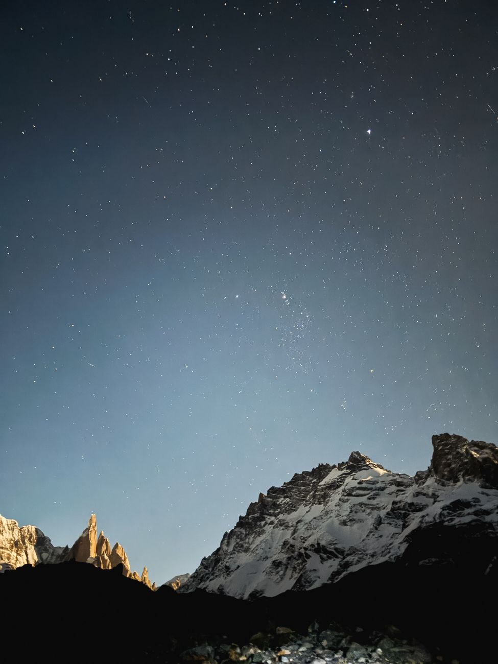 Majestic mountain range under starry night sky in Andean wilderness